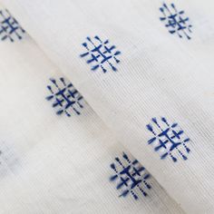 blue and white fabric with small snowflakes on it's edges, as well as the design