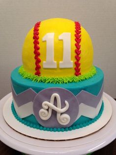 a birthday cake decorated with a baseball and number 11 on the top, sitting on a plate