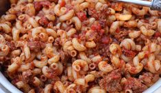 a bowl filled with pasta and meat sauce