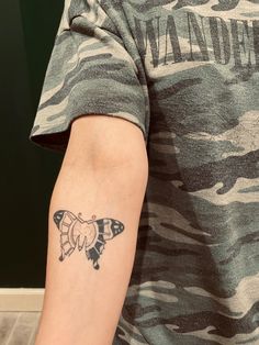 a man with a small tattoo on his arm