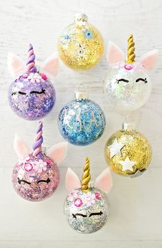 unicorn ornaments with glitter on them are arranged in a circle