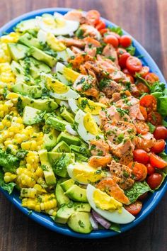 a blue bowl filled with different types of vegetables