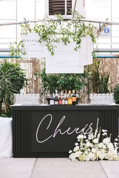 an outdoor bar set up with bottles and flowers