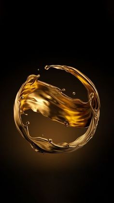 a gold ring with water splashing out of it's center on a black background