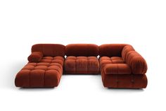 an orange couch and ottoman sitting on top of a white floor next to each other