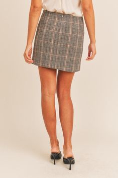 The Aretta Plaid Mini Skirt will be your go-to from day to night. Crafted from a soft wool-blend, this timeless plaid design features an asymmetric hem and statement tartan pattern. The ideal piece for stylish winter looks. Embrace your academic side in this dark, academia-inspired skirt. You'll be able to create so many aesthetically pleasing looks in this skirt, ranging from dark academia to 2000s posh. Crafted with luxurious details, like the front and back pleats, and a comfortable, high-wai Fall Plaid Mini Length Bottoms, Plaid Mini Skirt For Fall, Trendy Plaid Skort For Fall, Chic Plaid Mini Skirt Bottoms, Plaid Lined Skirt For Workwear, Houndstooth Mini Skirt For Fall, Fall Plaid Mini Skirt, Fall Plaid Lined Mini Skirt, Plaid Relaxed Work Skirt