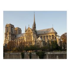 an old cathedral with towers and spires is seen from across the river in france