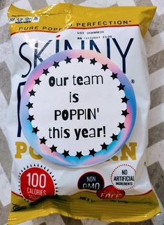 a bag of skinnyy popcorn with the words our team is popin'this year