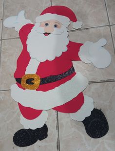 a paper cut out of santa clause on the floor