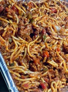 a pan full of spaghetti with meat and vegetables