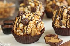 chocolate covered cupcakes with caramel and nuts on top are ready to be eaten