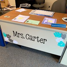 an office desk with the name mrs carter on it's front and side