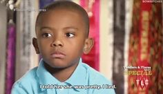 a little boy with a blue shirt and some words on the screen in front of him