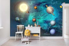 the solar system wallpaper mural in a child's room with chairs and table