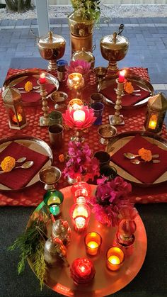 the table is set with candles and plates