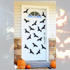 a white door decorated with bats and pumpkins