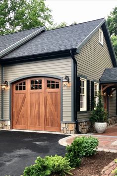 a house with two garage doors and windows