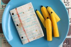 a blue plate topped with bananas and rice krispy kreme sticks next to each other