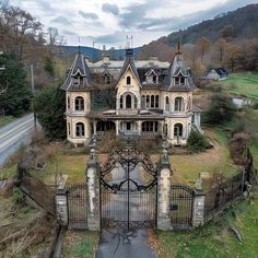 an aerial view of a large house with a gate