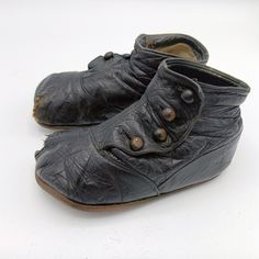 Baby or toddler button up shoes from the late 1800s.  High button shoes have four buttons on sides.  Very nicely worn black shoes will serve well as a photo prop, nursery décor, or add to your collection of Victorian Era child wear.  The leather is still as soft as it probably once was and pliable.  The left shoe is more worn than the right.  They show signs of wear on the soles, but particularly on the toes.  In the days of "making do, wear it out or pass it on" the little guy who wore these wo Baby Leather Shoes, Leather Baby Shoes, Up Shoes, Toddler Shoes, Handmade Baby, Victorian Era, Wearing Black, Shoes Black, Kids Wear