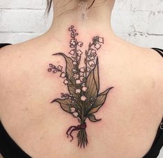 the back of a woman's neck with flowers on it