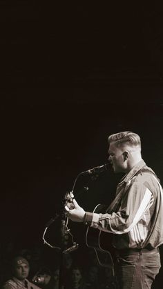 a man that is standing up with a microphone