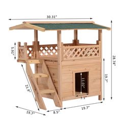 a wooden play house with a green roof and stairs to the upper level that leads up to the second floor