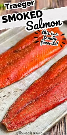 two raw salmons sitting on top of a baking sheet with the words traeger smoked smoked salmon