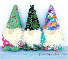 three colorful gnomes sitting next to each other