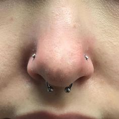 the nose has three piercings on it