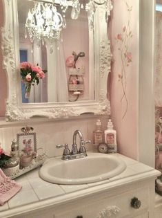 a white bathroom sink sitting under a mirror