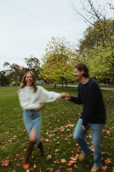 two people are playing frisbee in the grass