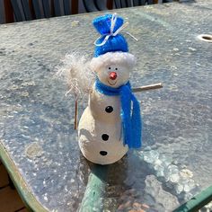 a snowman sitting on top of a metal table