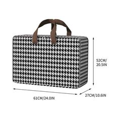 a black and white checkered bag with brown handles, measurements for the handle on it