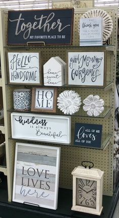 a display case filled with lots of different types of handmade signs and decorations on it