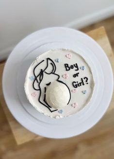 a cake that is on top of a plate with the words boy or girl written on it