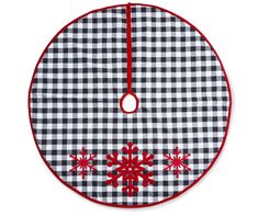 a black and white checkered christmas ornament with red snowflakes on it