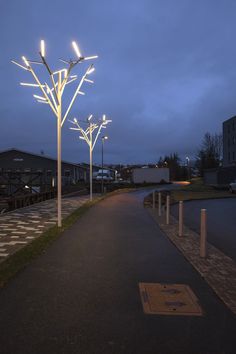 an empty walkway with lights on it at night