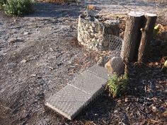 a stone bench sitting on top of a dirt field