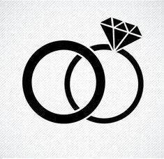 two wedding rings with a diamond on the top and one in the middle, against a white background