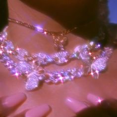 a close up of a woman's chest wearing a necklace with stars on it