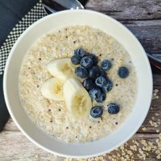 a bowl of oatmeal with blueberries and banana slices on the side