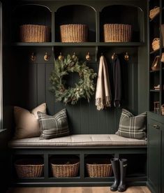 a bench with some baskets on it and a wreath hanging from the wall next to it