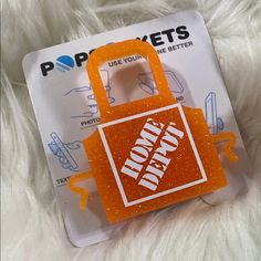 an orange and white bag with the words don't pokes on it sitting in front of a card