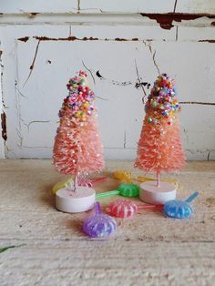 two pink christmas trees with sprinkles on them and candy lollipops