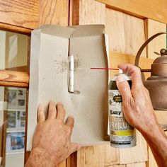 a man is painting the inside of a box with glue and a paintbrush on it