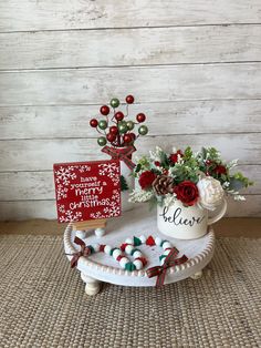 a christmas arrangement with flowers and other holiday decorations