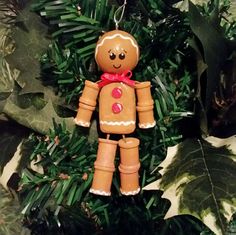 a gingerbread man ornament hanging from a christmas tree