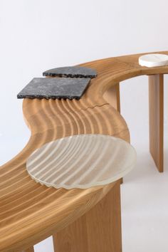 a close up of a wooden bench with glass plates on the top and bottom edge