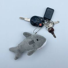 a stuffed shark keychain with keys attached to it